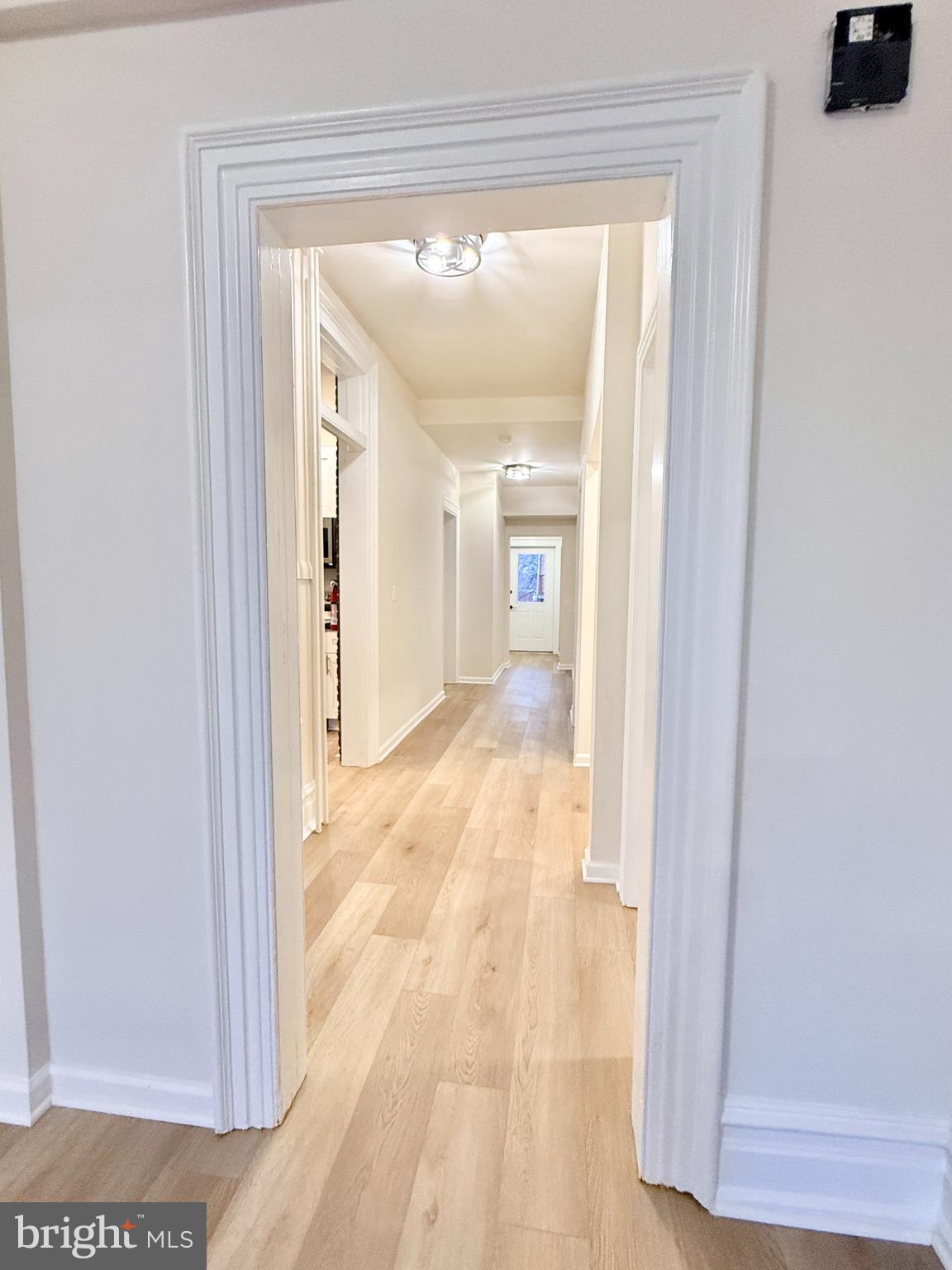123 North Hanover Street, Unit 1 Pottstown, PA 19464 - Photo 13 of 22 a view of a hallway with wooden floor and a living room