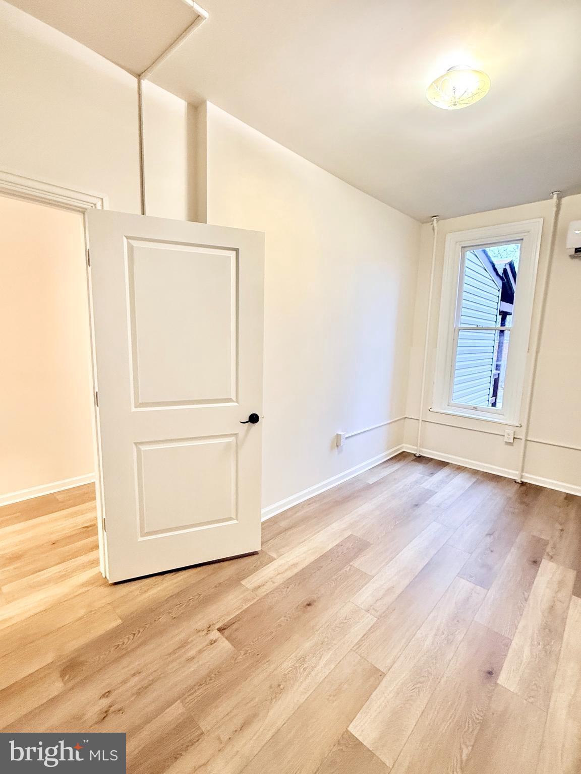 123 North Hanover Street, Unit 1 Pottstown, PA 19464 - Photo 15 of 22 an empty room with wooden floor cabinet and windows