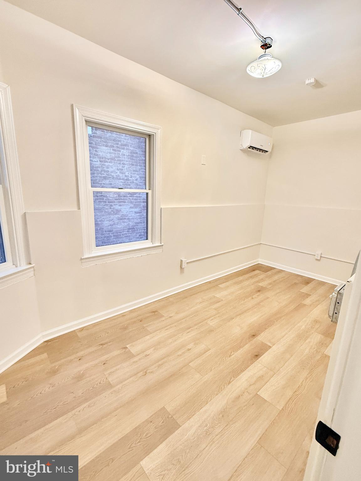 123 North Hanover Street, Unit 1 Pottstown, PA 19464 - Photo 17 of 22 an empty room with wooden floor and windows