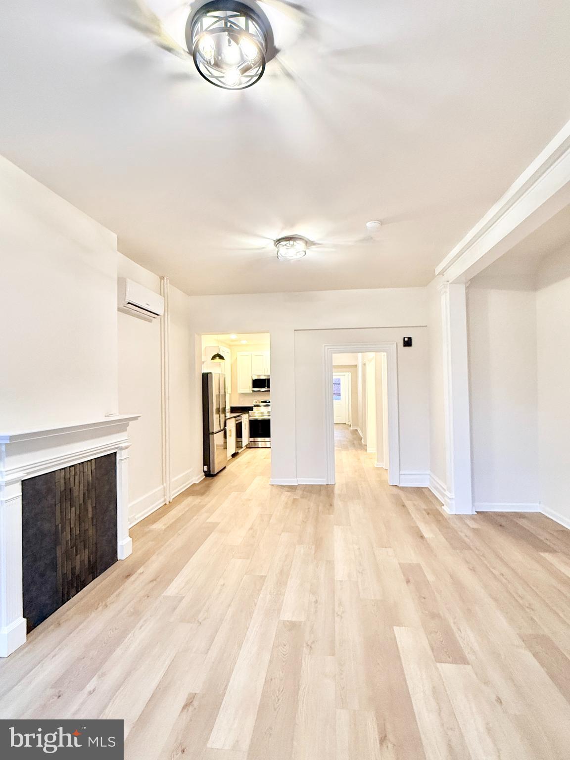 123 North Hanover Street, Unit 1 Pottstown, PA 19464 - Photo 5 of 22 a view of a livingroom with wooden floor and a fireplace