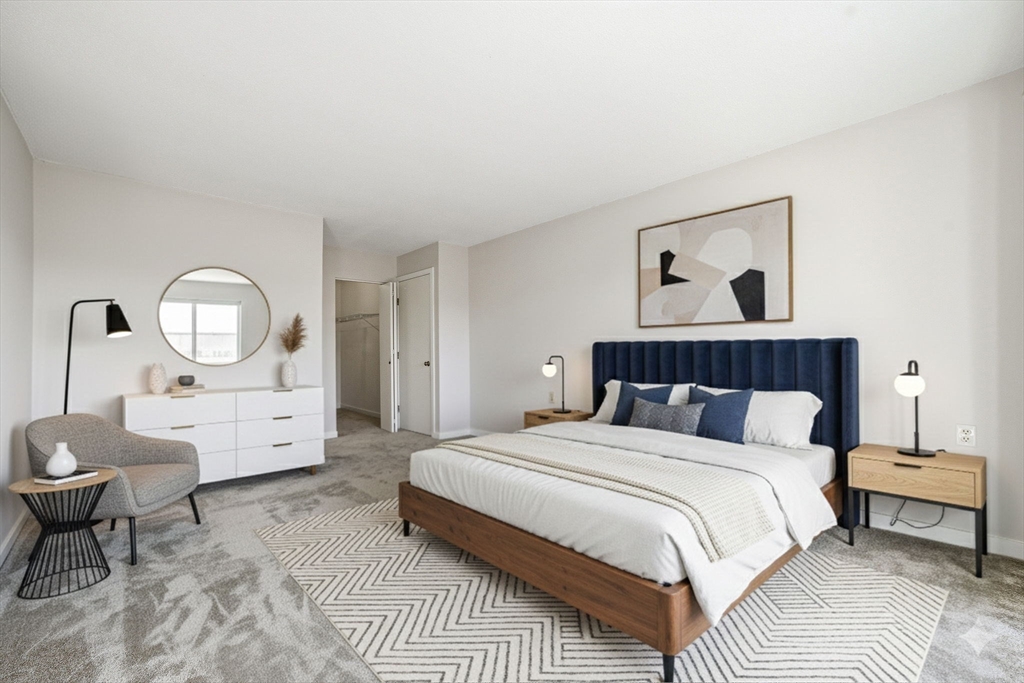 100 Rosemary Way, Unit 324 Needham, MA 02494 - Photo 11 of 27 a bed room with a bed and a potted plant