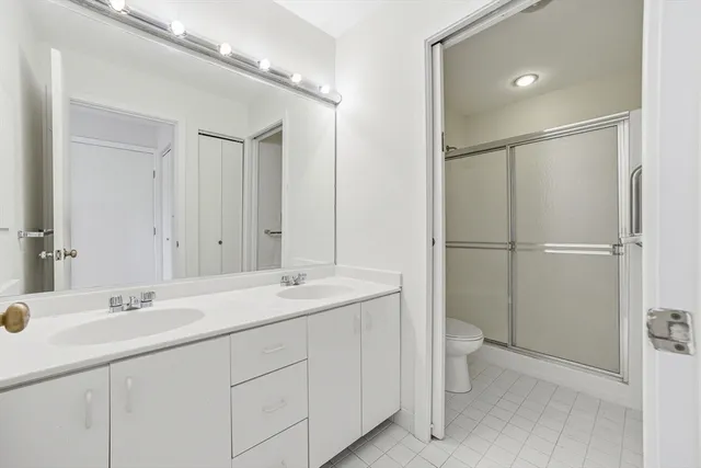 a white toilet sitting next to a shower