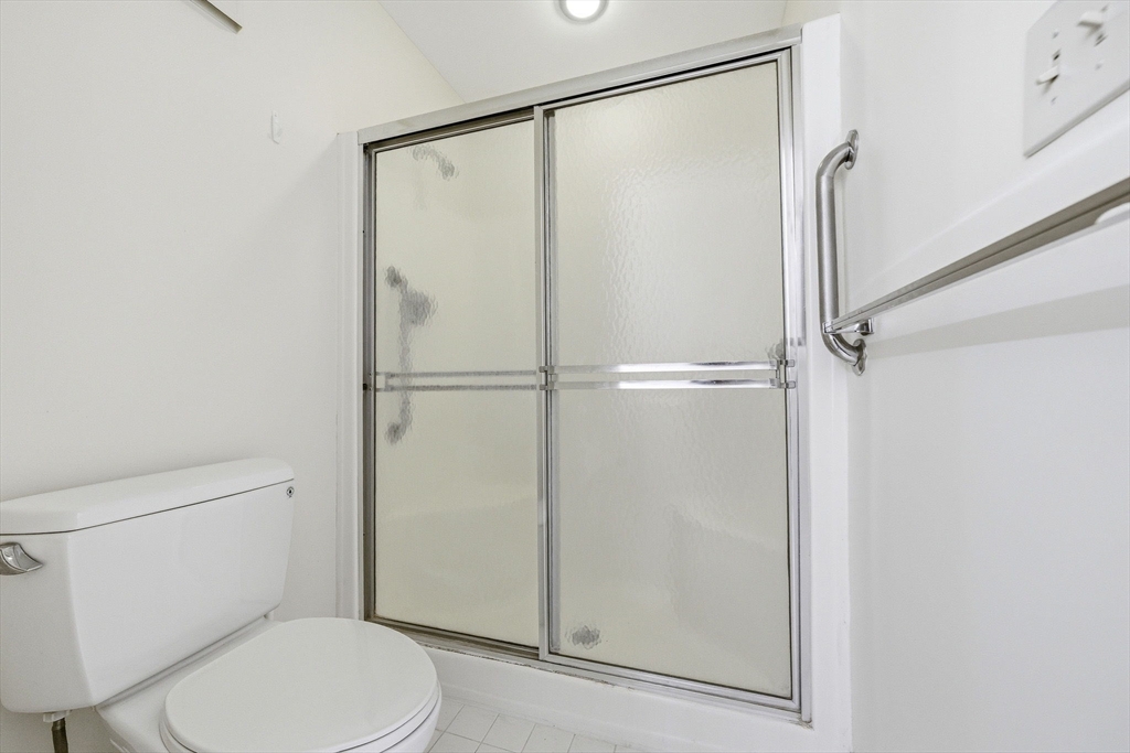 100 Rosemary Way, Unit 324 Needham, MA 02494 - Photo 14 of 27 a white toilet sitting next to a shower
