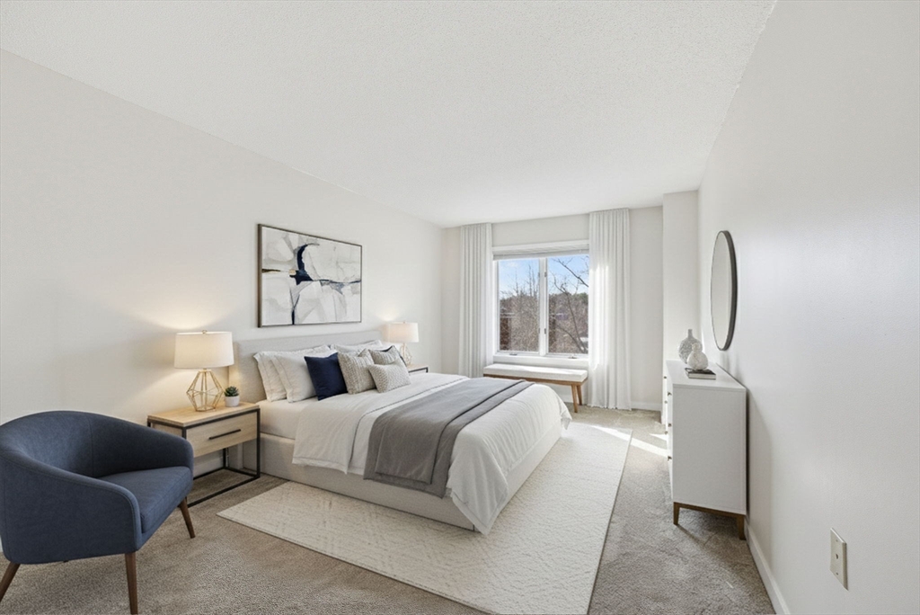 100 Rosemary Way, Unit 324 Needham, MA 02494 - Photo 16 of 27 a bedroom with a bed and a window