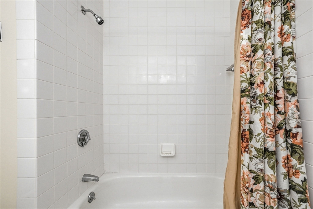 100 Rosemary Way, Unit 324 Needham, MA 02494 - Photo 20 of 27 a bathroom with a shower curtain