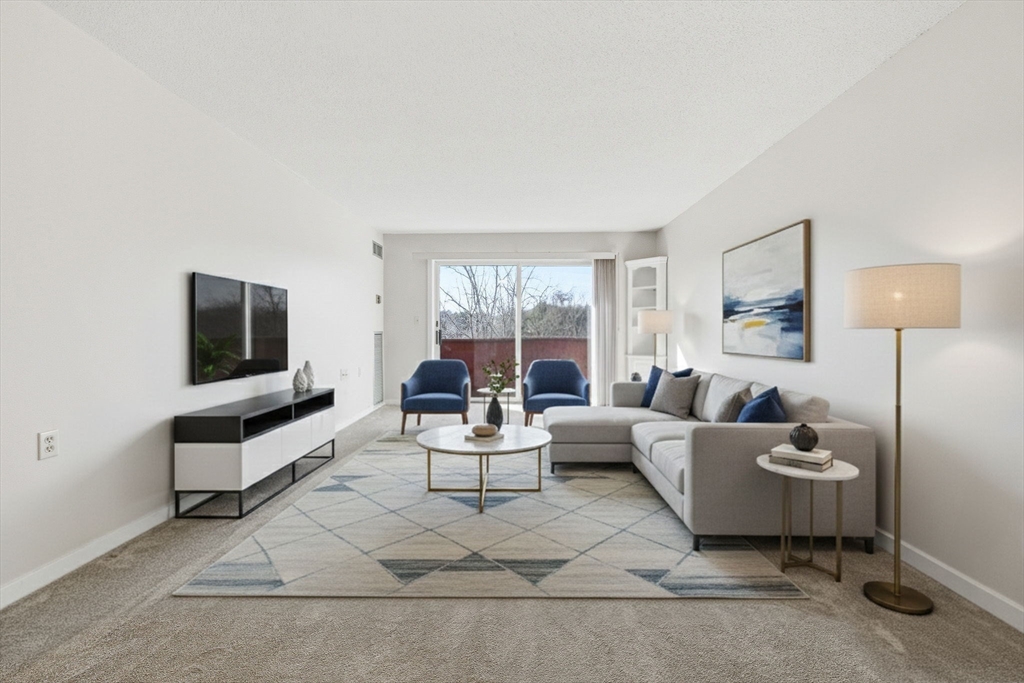 100 Rosemary Way, Unit 324 Needham, MA 02494 - Photo 4 of 27 a living room with furniture and a flat screen tv
