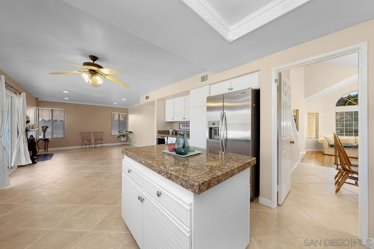 13558 Quiet Hills Drive Poway, CA 92064 - Photo 11 of 61 a kitchen with granite countertop kitchen island stainless steel appliances a sink stove and refrigerator