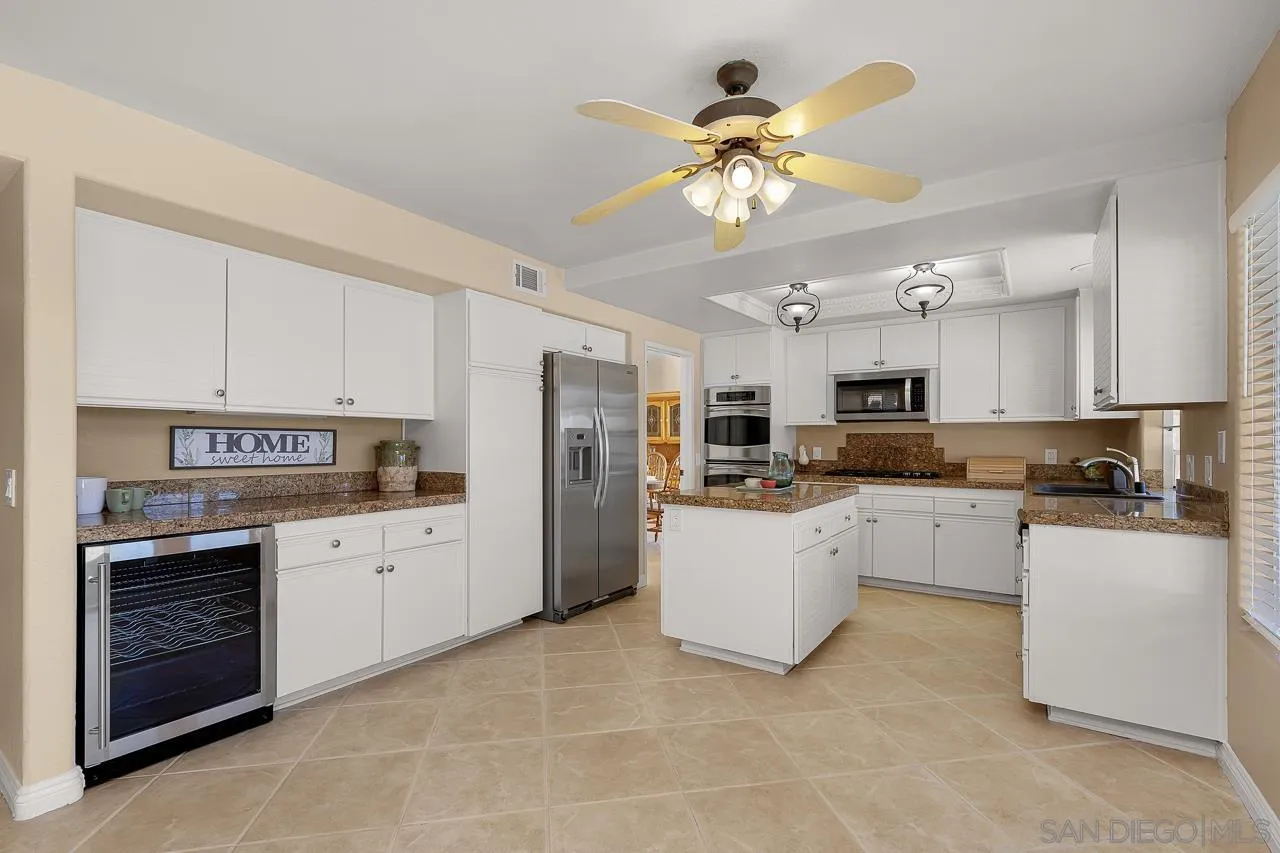 13558 Quiet Hills Drive Poway, CA 92064 - Photo 12 of 61 a kitchen with stainless steel appliances a refrigerator sink and stove
