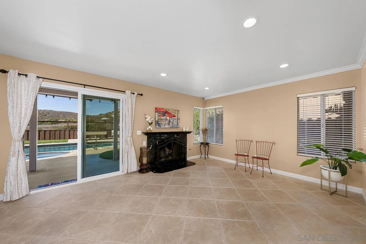 13558 Quiet Hills Drive Poway, CA 92064 - Photo 15 of 61 a living room with furniture a flat screen tv and a fireplace