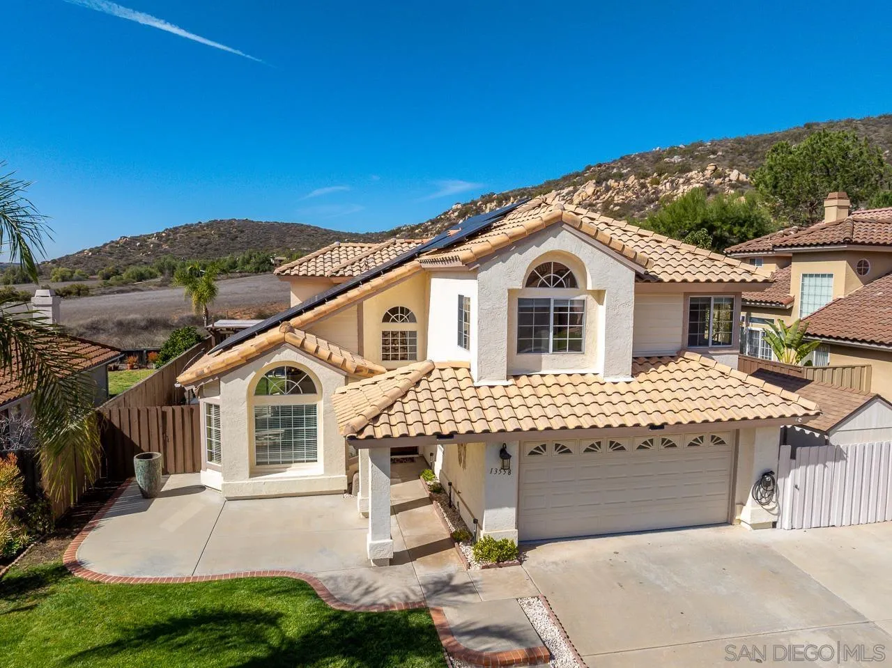 13558 Quiet Hills Drive Poway, CA 92064 - Photo 2 of 61 a front view of a house with a garden