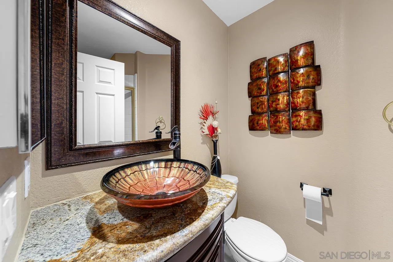 13558 Quiet Hills Drive Poway, CA 92064 - Photo 21 of 61 a room with a couch and a potted plant