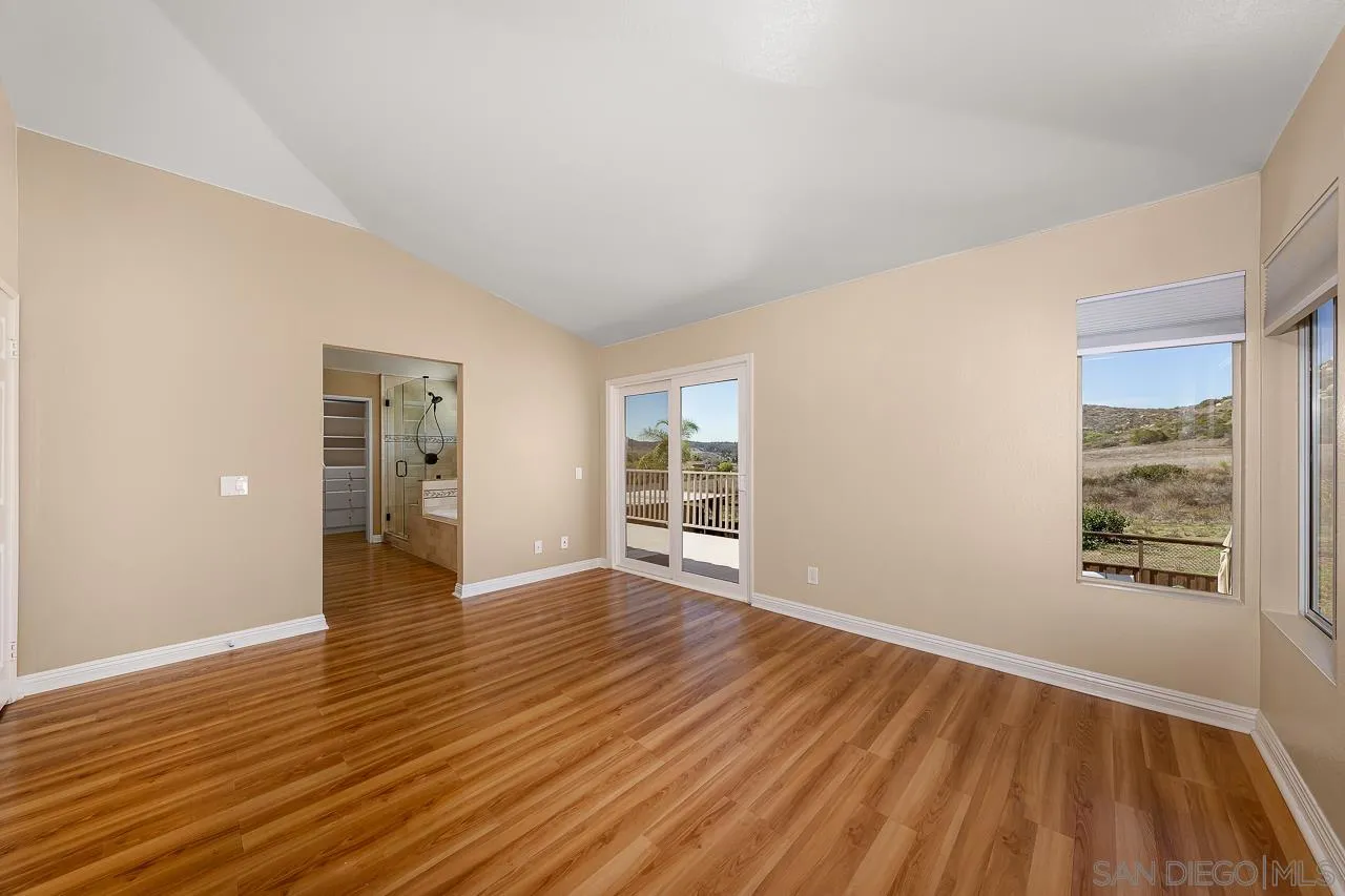 13558 Quiet Hills Drive Poway, CA 92064 - Photo 23 of 61 a view of an empty room with wooden floor and a window
