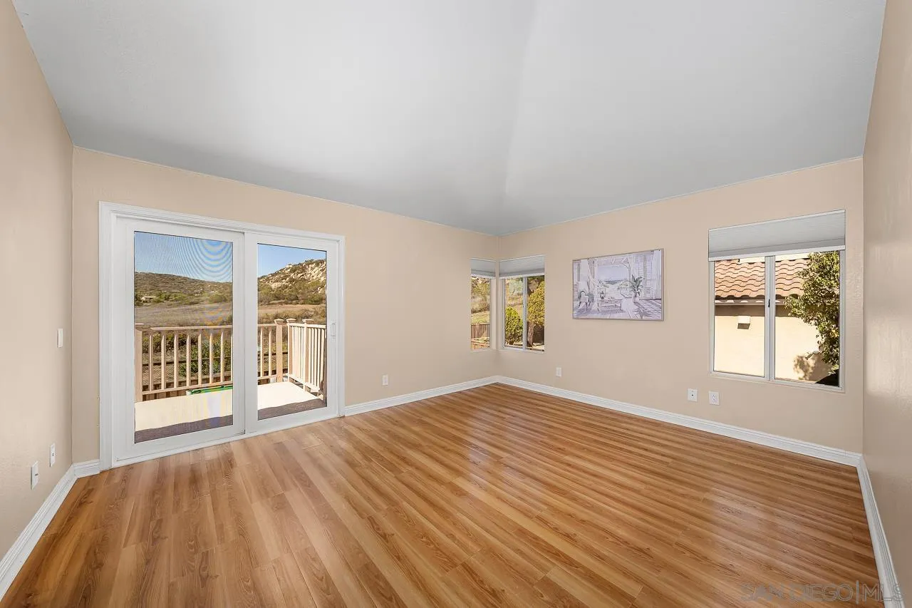 13558 Quiet Hills Drive Poway, CA 92064 - Photo 24 of 61 an empty room with wooden floor and windows