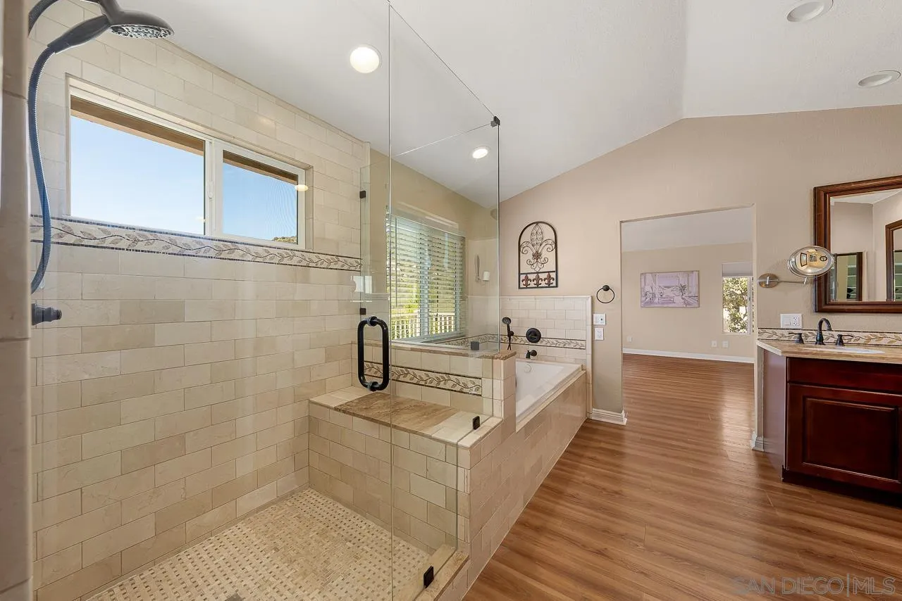 13558 Quiet Hills Drive Poway, CA 92064 - Photo 30 of 61 a spacious bathroom with a double vanity sink a mirror and a bathtub