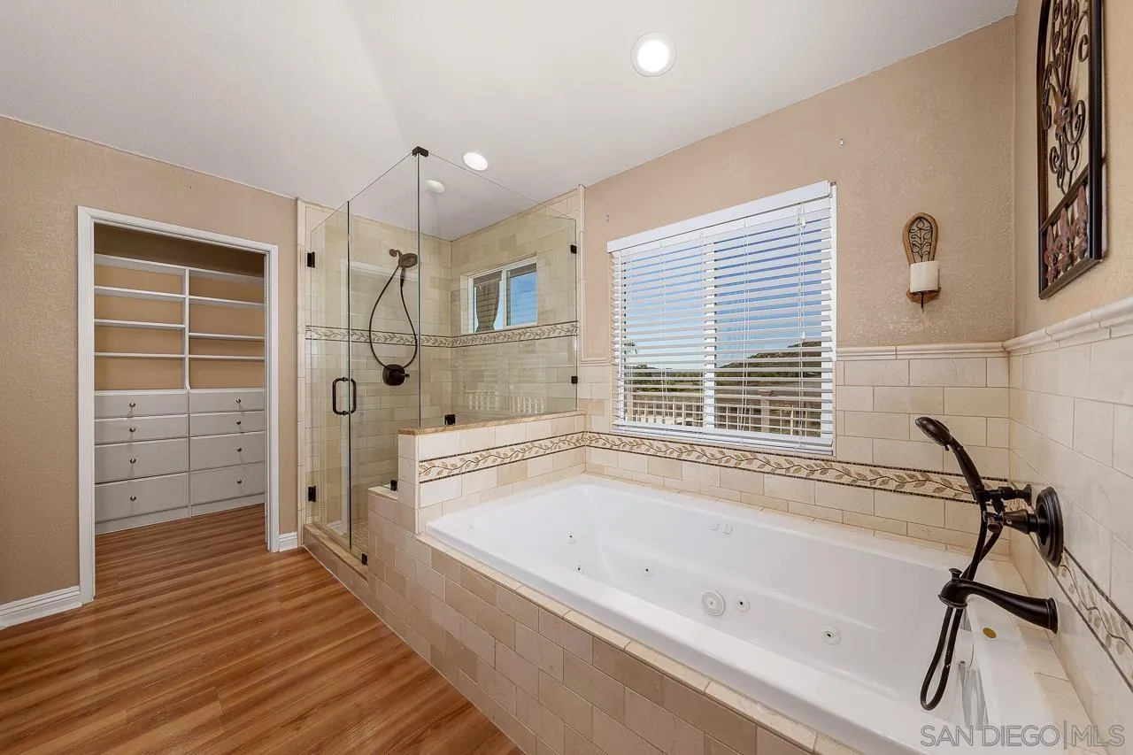 13558 Quiet Hills Drive Poway, CA 92064 - Photo 31 of 61 a spacious bathroom with a tub a sink and a shower