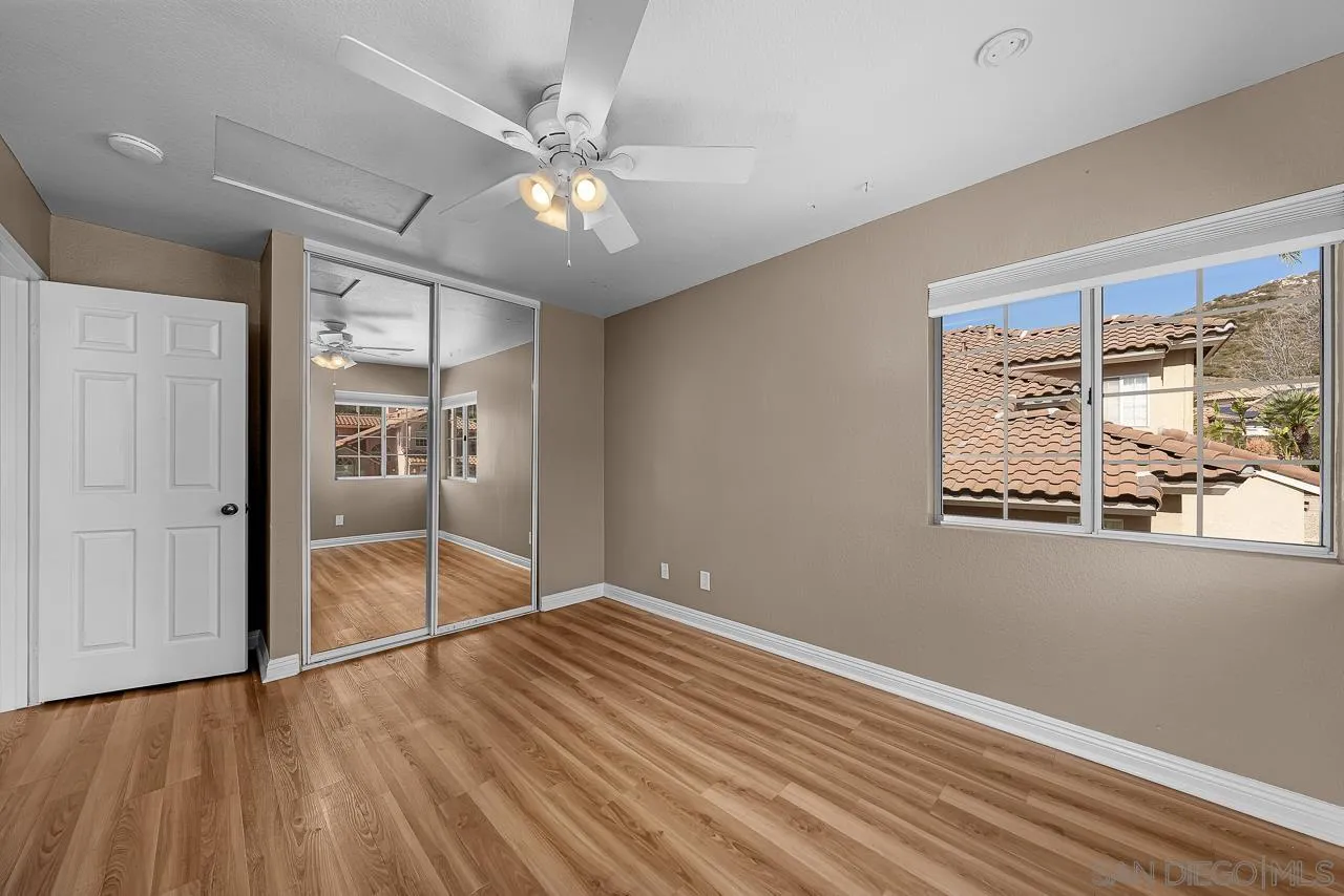 13558 Quiet Hills Drive Poway, CA 92064 - Photo 39 of 61 a view of an empty room with wooden floor and a window