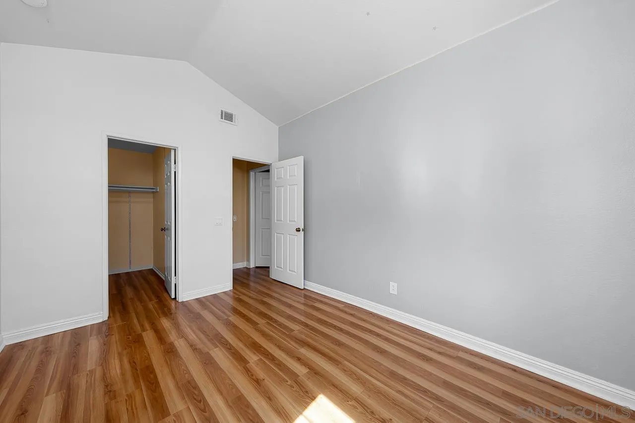 13558 Quiet Hills Drive Poway, CA 92064 - Photo 42 of 61 a view of a room with wooden floor and a ceiling fan