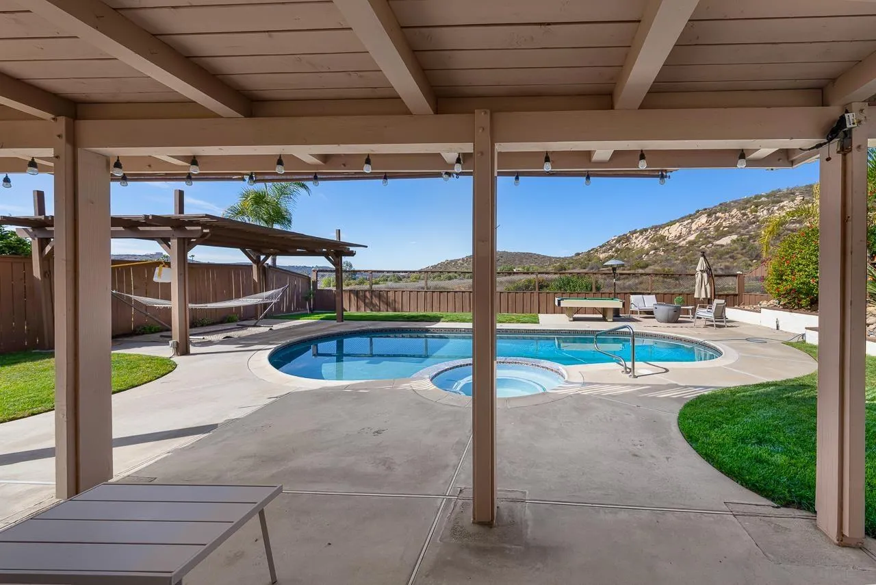13558 Quiet Hills Drive Poway, CA 92064 - Photo 46 of 61 a view of a swimming pool with a porch