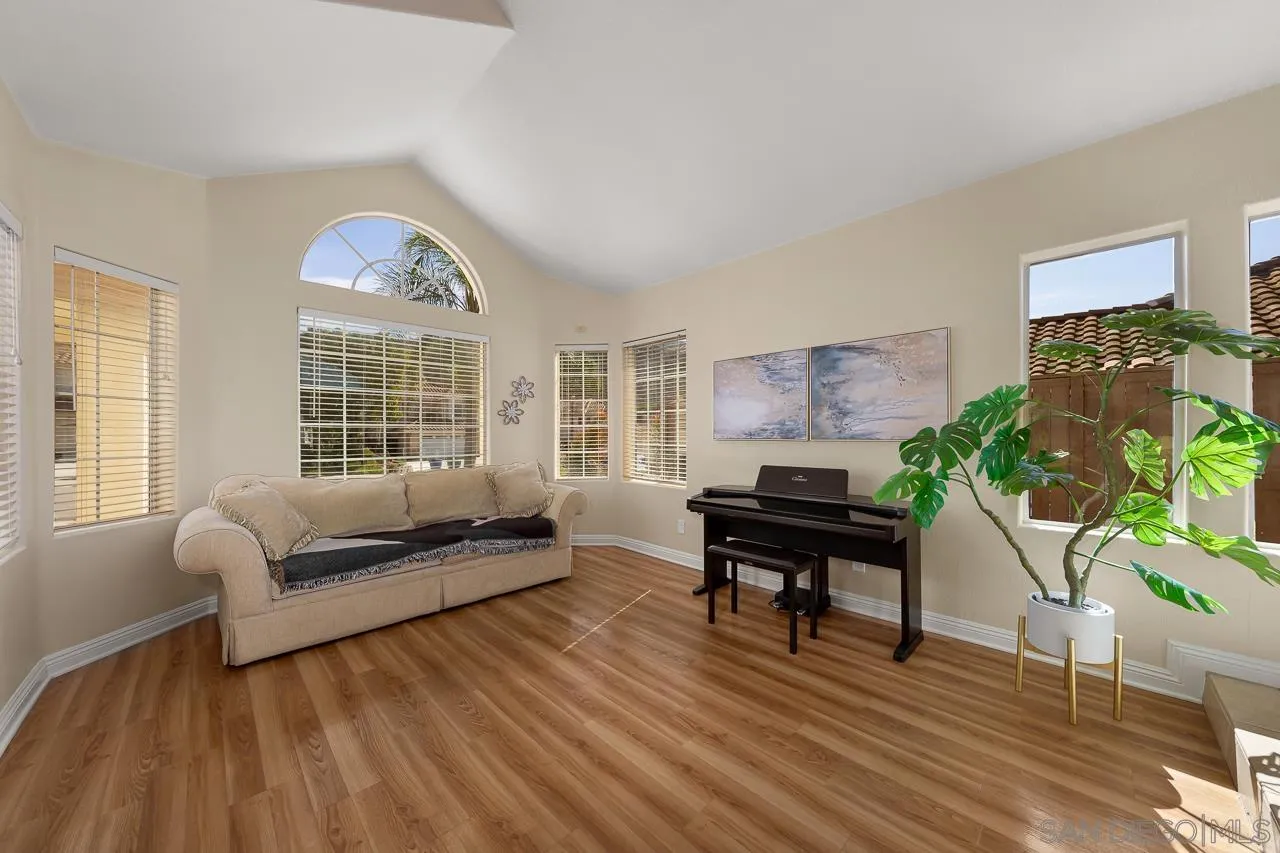 13558 Quiet Hills Drive Poway, CA 92064 - Photo 6 of 61 a living room with furniture and a potted plant next to a window