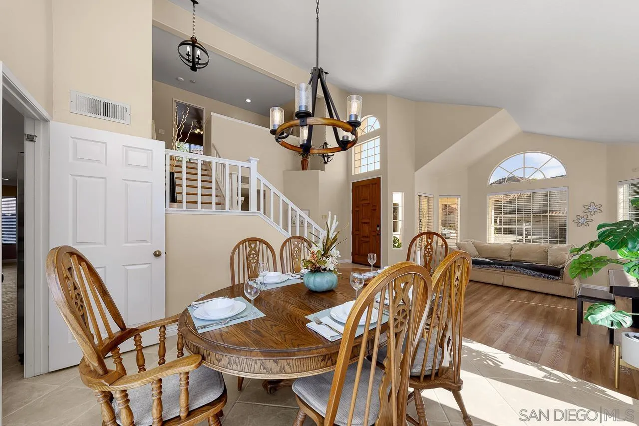 13558 Quiet Hills Drive Poway, CA 92064 - Photo 8 of 61 a dining room with furniture a chandelier and wooden floor