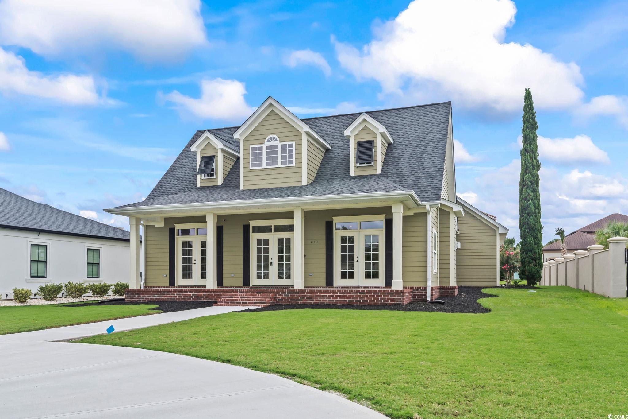 Cape cod-style house featuring french doors and ro
