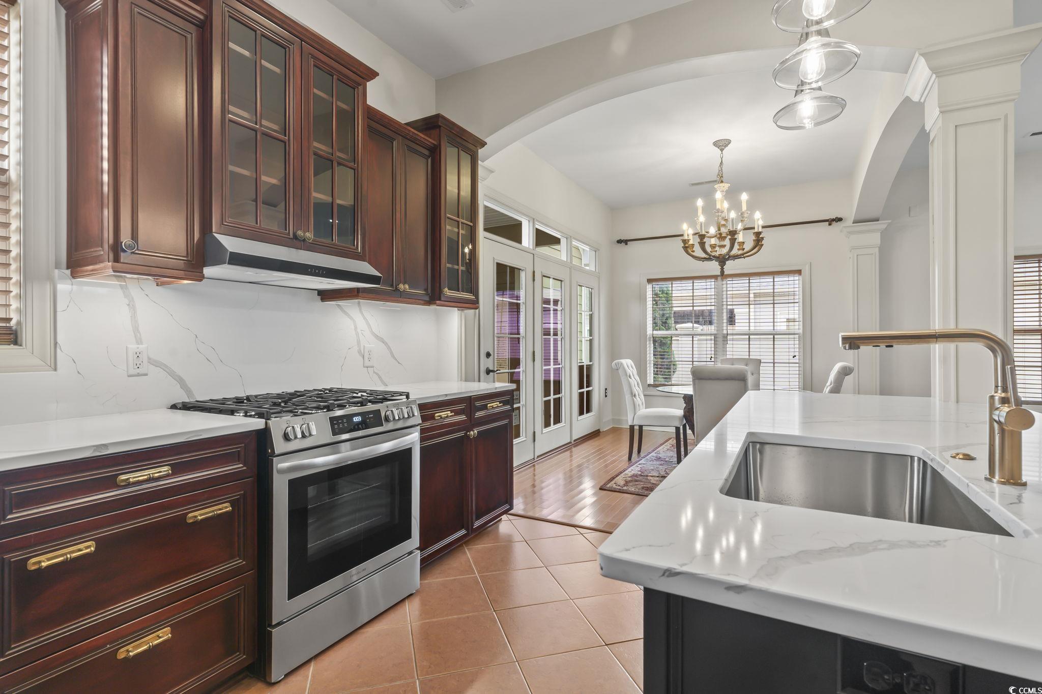 853 Bluffview Drive Myrtle Beach, SC 29579 - Photo 12 of 40 Kitchen with stainless steel gas stove, arched wal