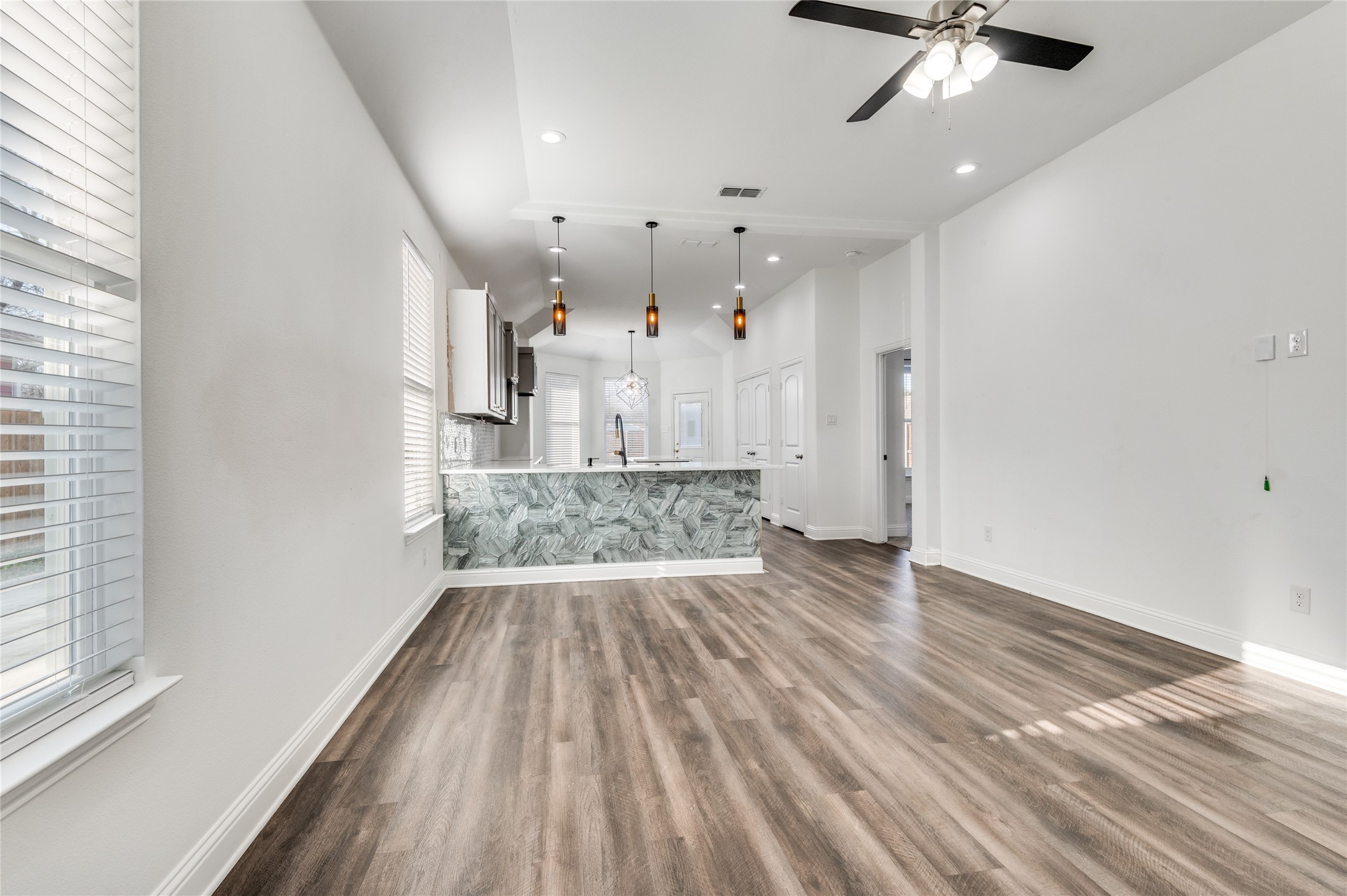 2255 Exeter Avenue Dallas, TX 75216 - Photo 12 of 30 en empty room with wooden floor fan and windows