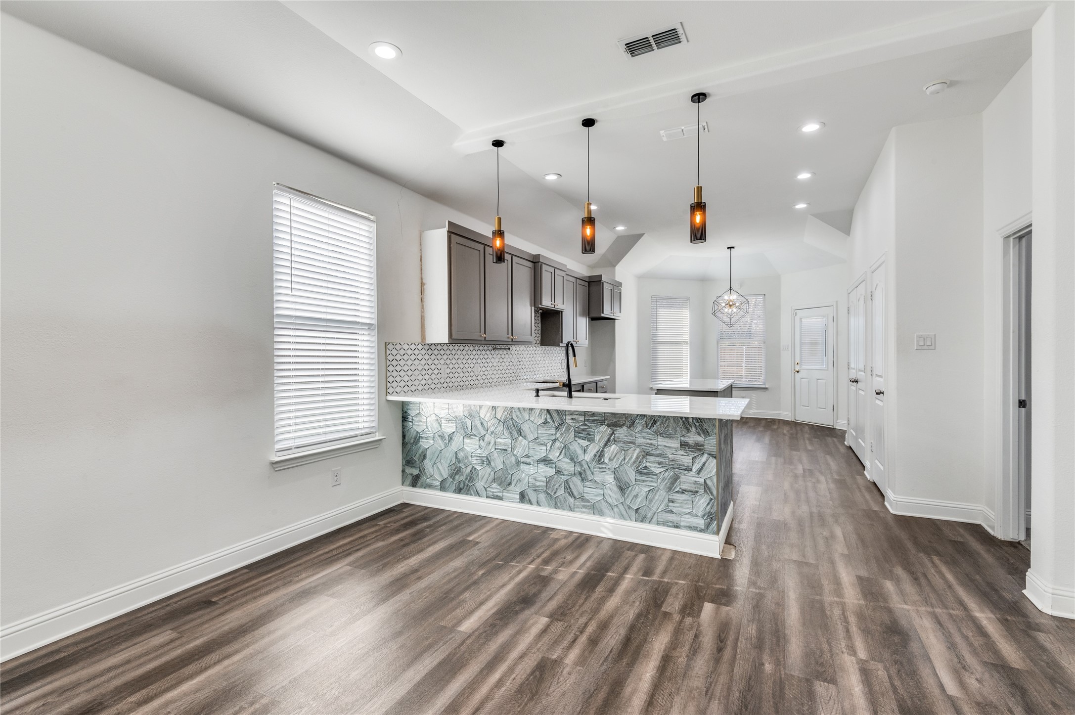 2255 Exeter Avenue Dallas, TX 75216 - Photo 14 of 30 a view of wooden floor and windows in a room
