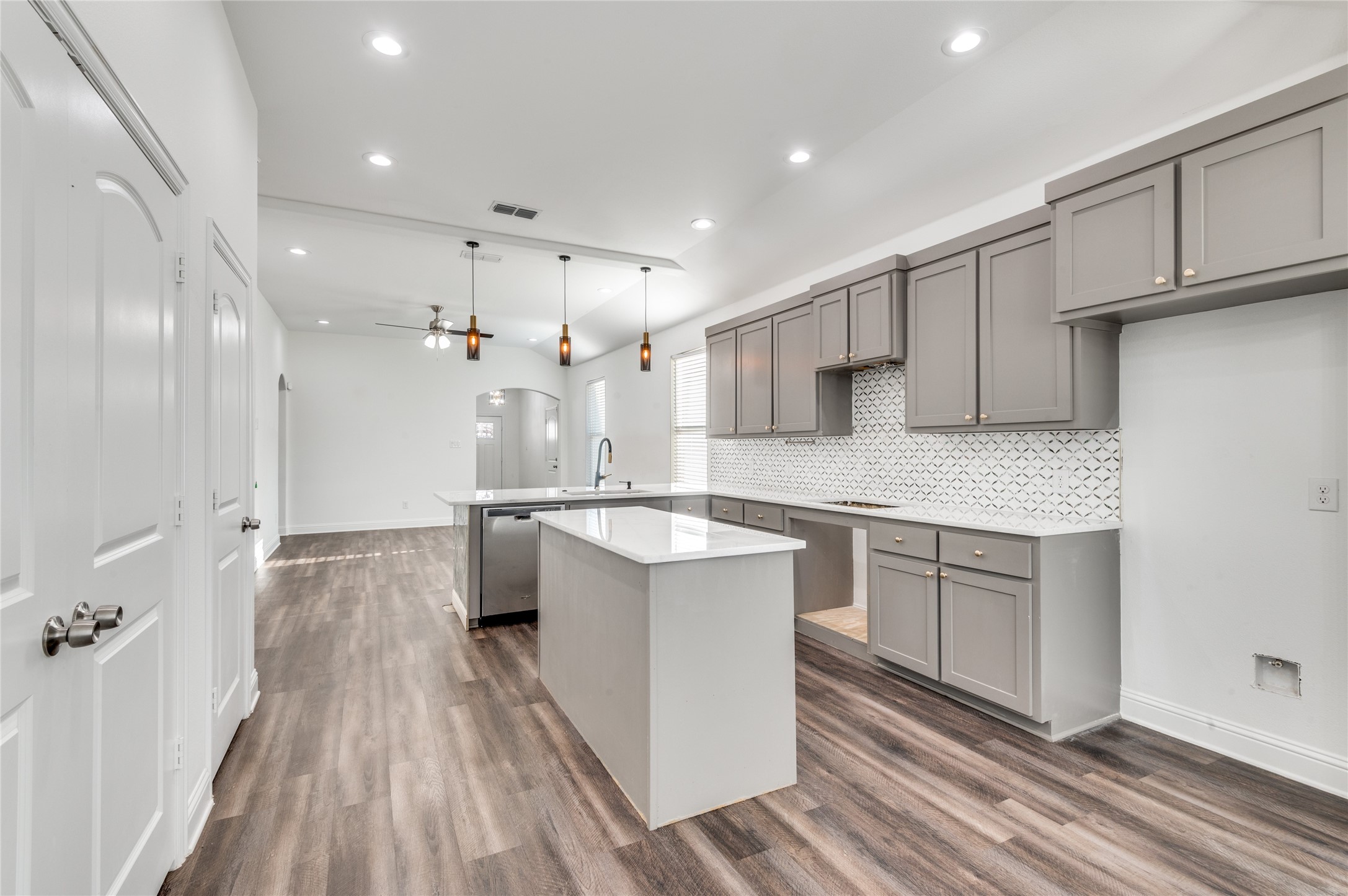 2255 Exeter Avenue Dallas, TX 75216 - Photo 18 of 30 a open kitchen with kitchen island white cabinets and stainless steel appliances