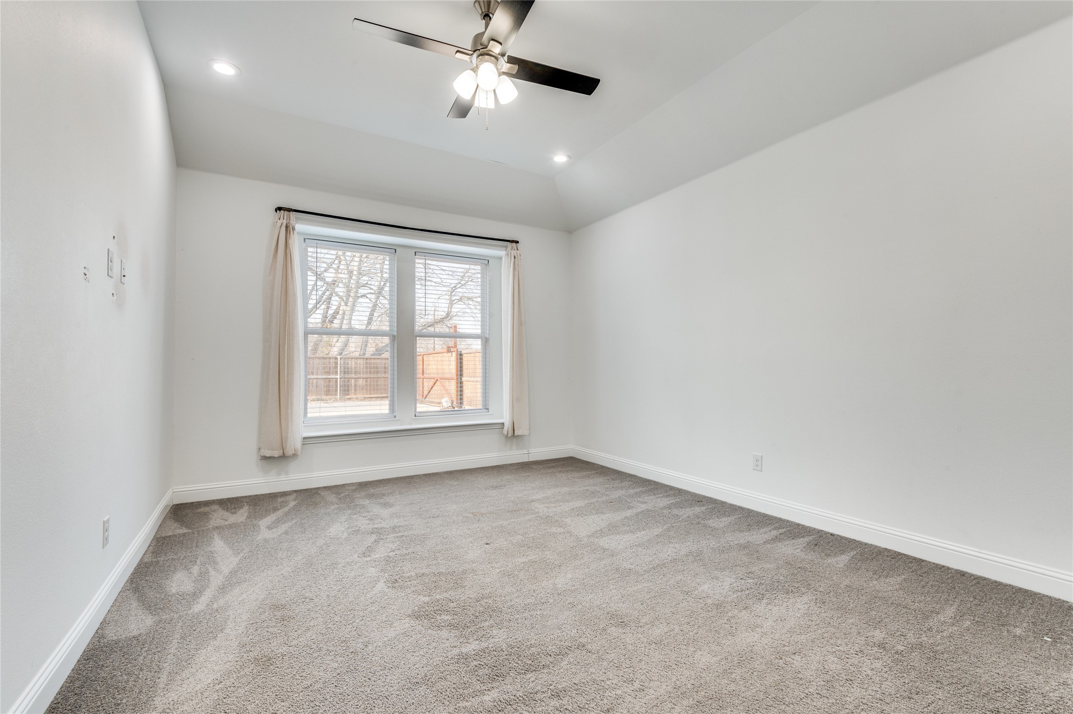2255 Exeter Avenue Dallas, TX 75216 - Photo 23 of 30 an empty room with windows and fan