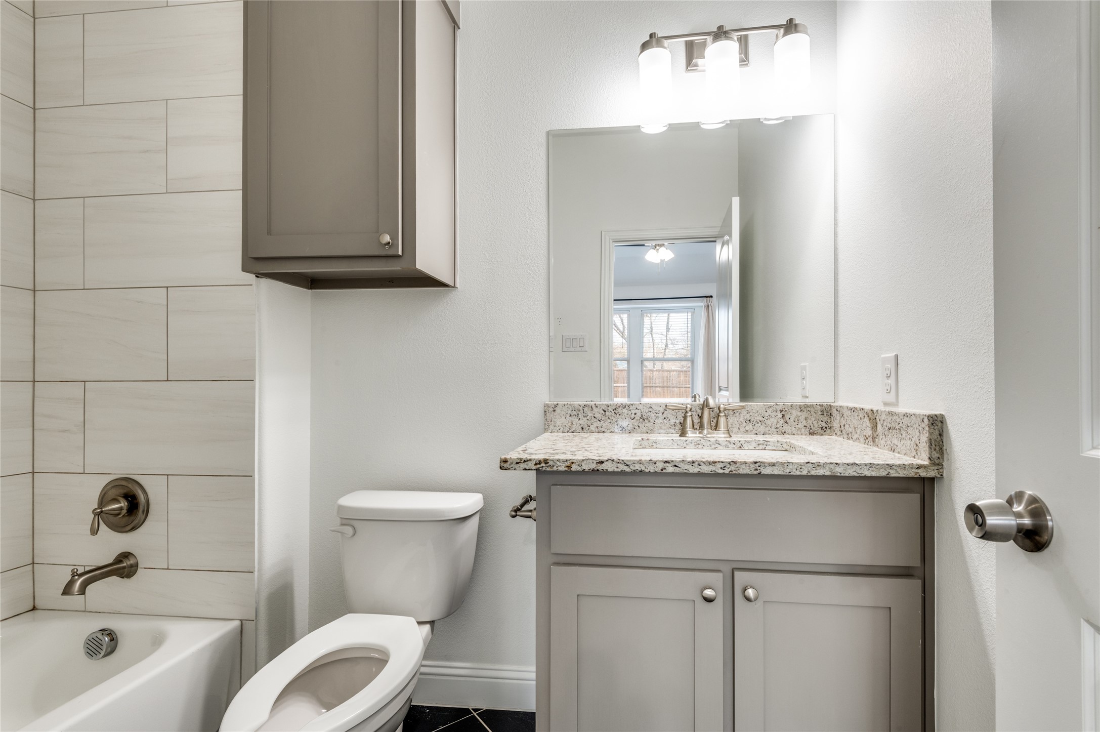 2255 Exeter Avenue Dallas, TX 75216 - Photo 24 of 30 a bathroom with a granite countertop sink toilet and mirror