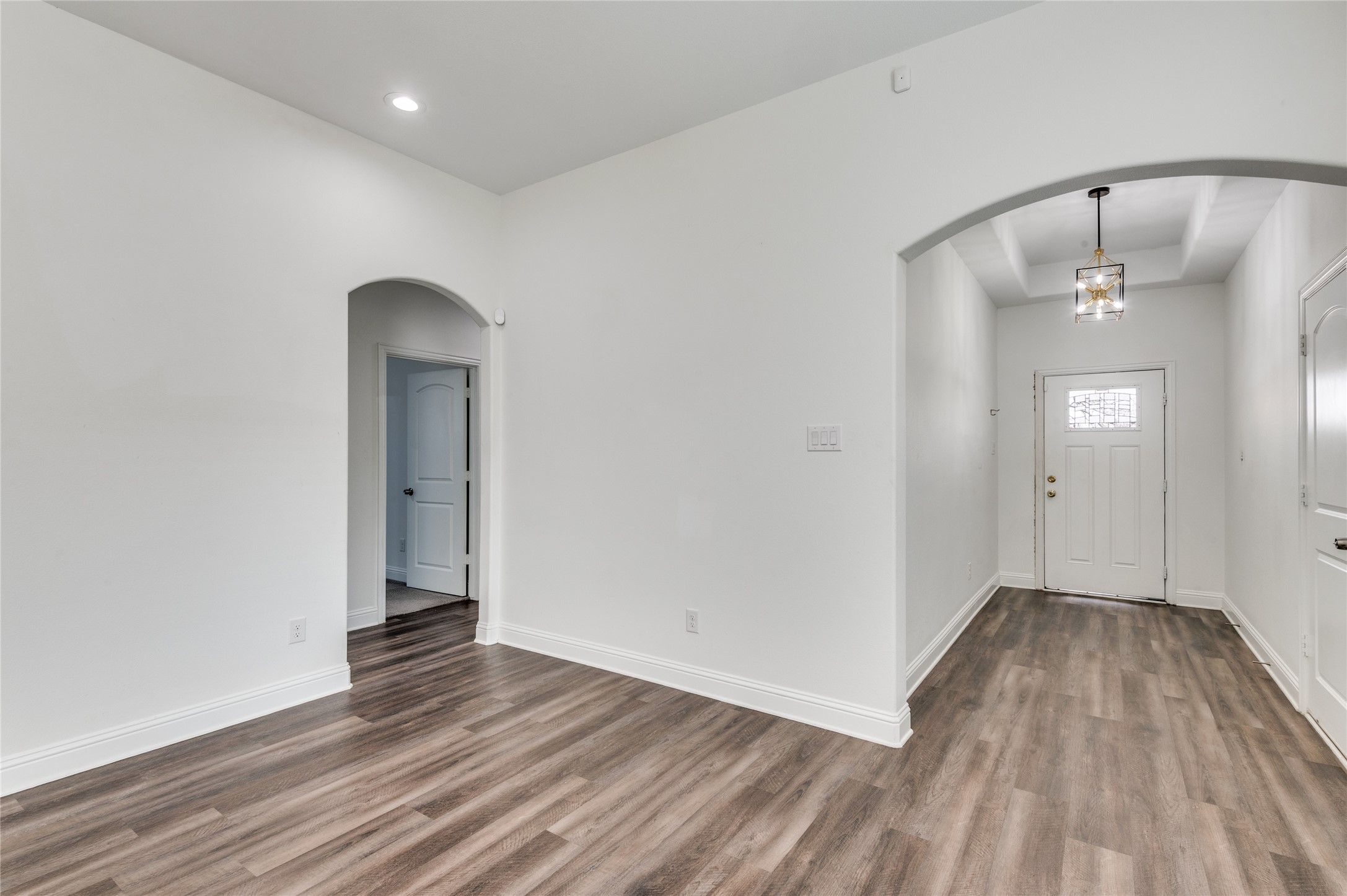 2255 Exeter Avenue Dallas, TX 75216 - Photo 8 of 30 an empty room with wooden floor and mirror