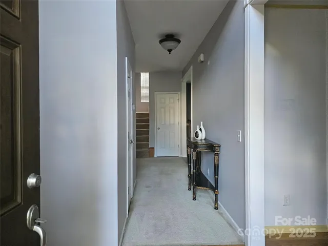 a view of a hallway with wooden shelves