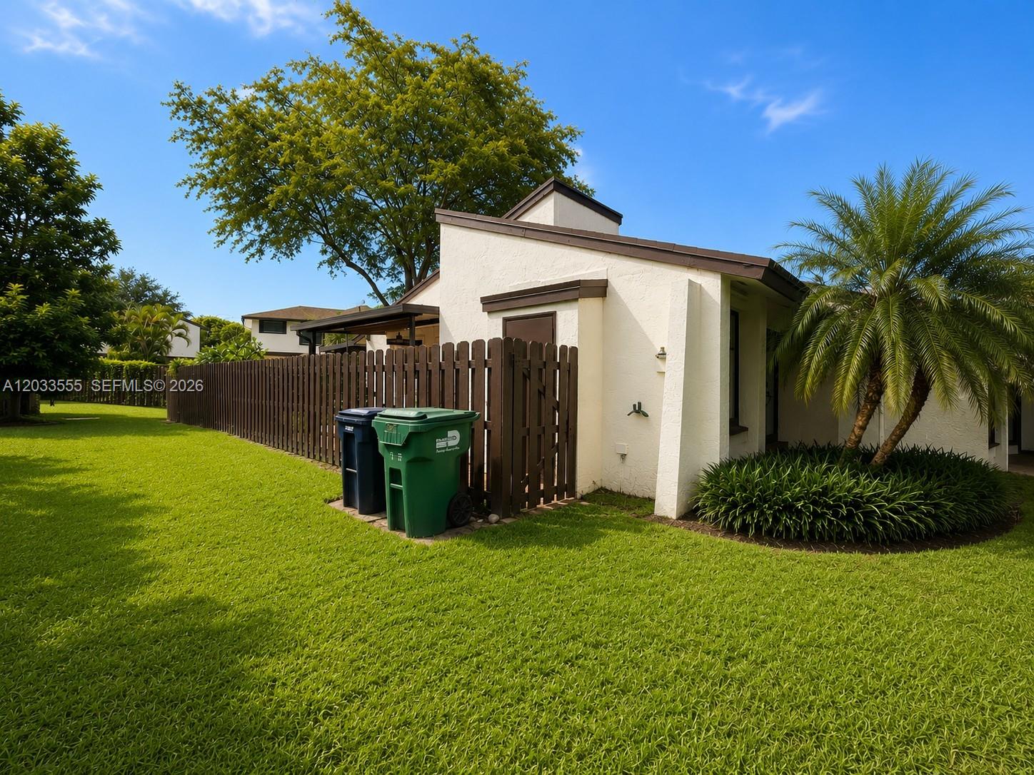 12737 Southwest 68th Terrace Miami, FL 33183 - Photo 4 of 32 Side exterior of the home featuring side door to yard.
