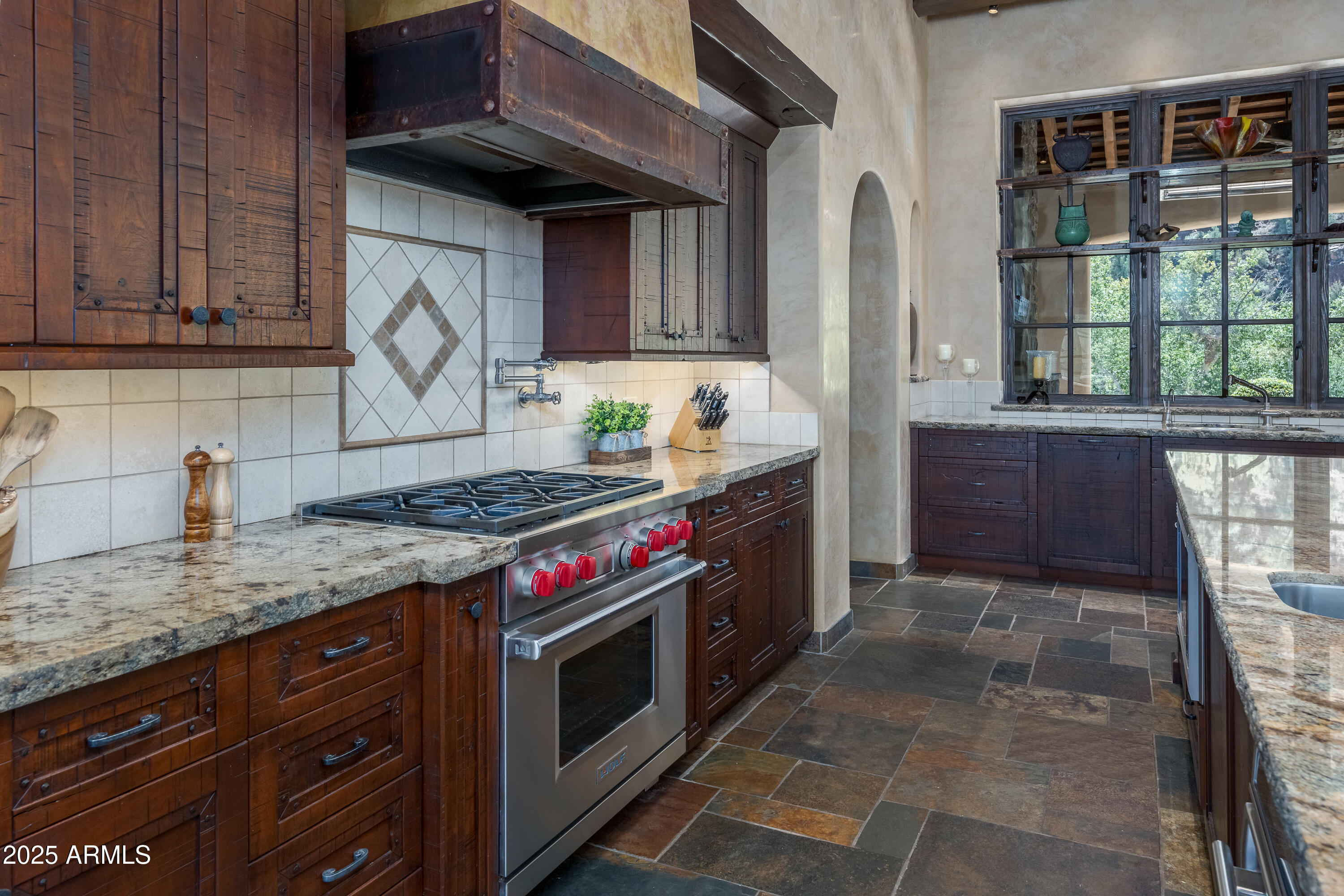 330 Eagle Mountain Ranch Road Sedona, AZ 86336 - Photo 17 of 87 a kitchen with stainless steel appliances granite countertop a stove a sink and a microwave