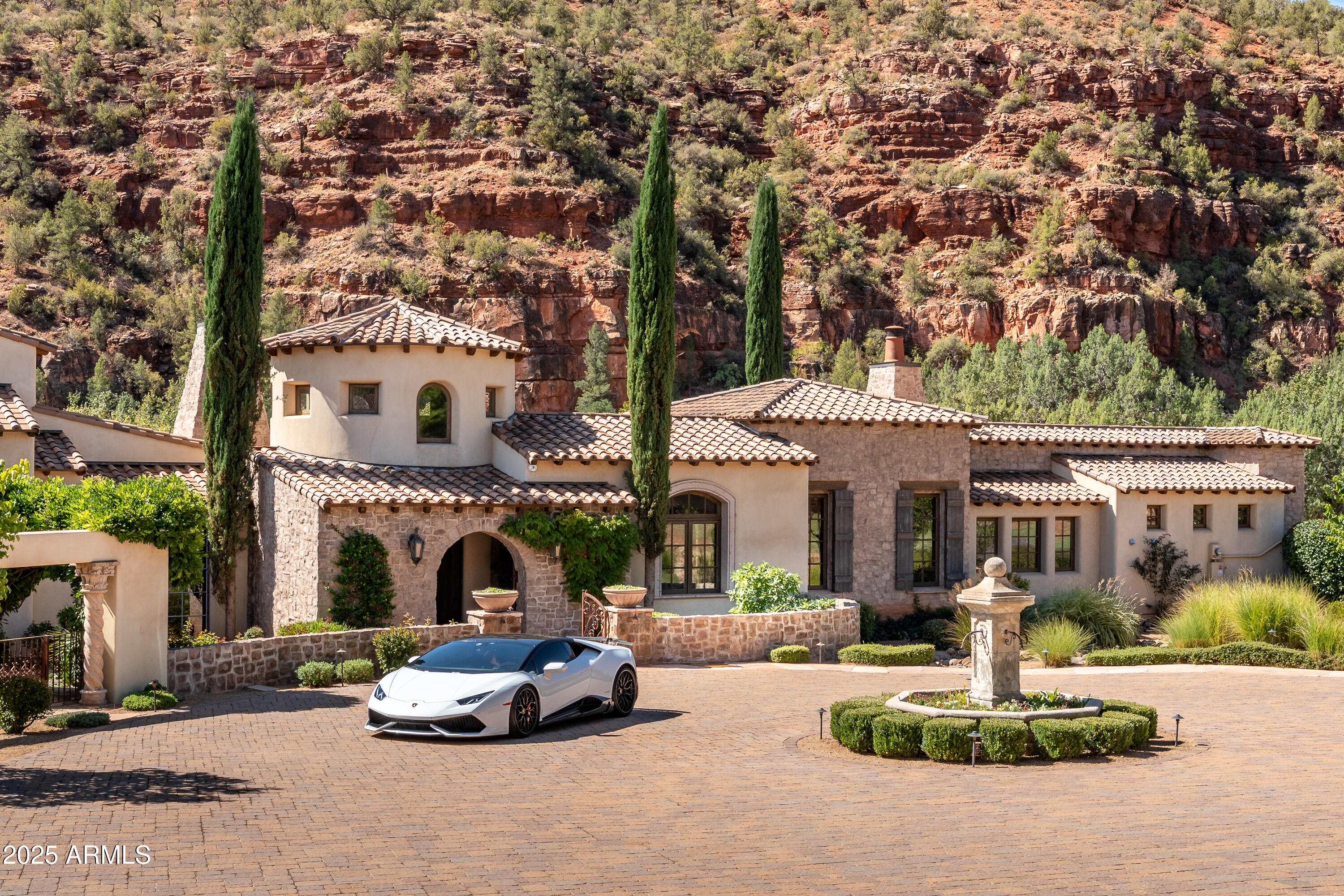 330 Eagle Mountain Ranch Road Sedona, AZ 86336 - Photo 2 of 87 a front view of a house with a garden and tree