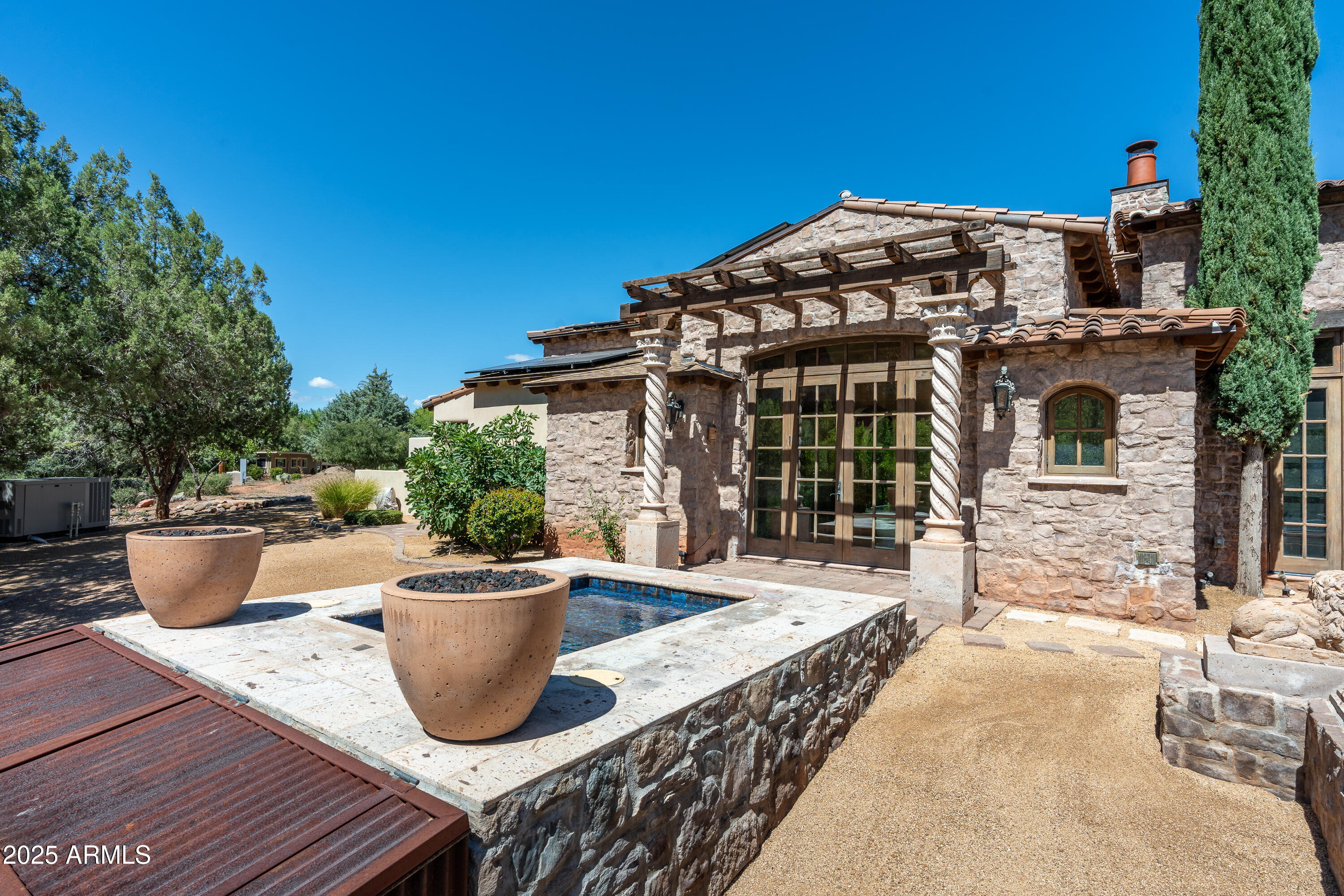 330 Eagle Mountain Ranch Road Sedona, AZ 86336 - Photo 55 of 87 a view of a patio with table and chairs and potted plants