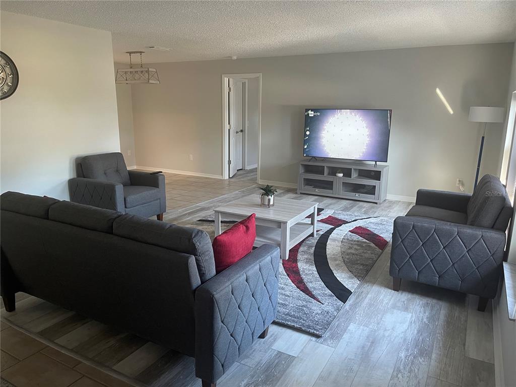 21 Post View Drive Palm Coast, FL 32164 - Photo 20 of 28 a living room with furniture and a flat screen tv