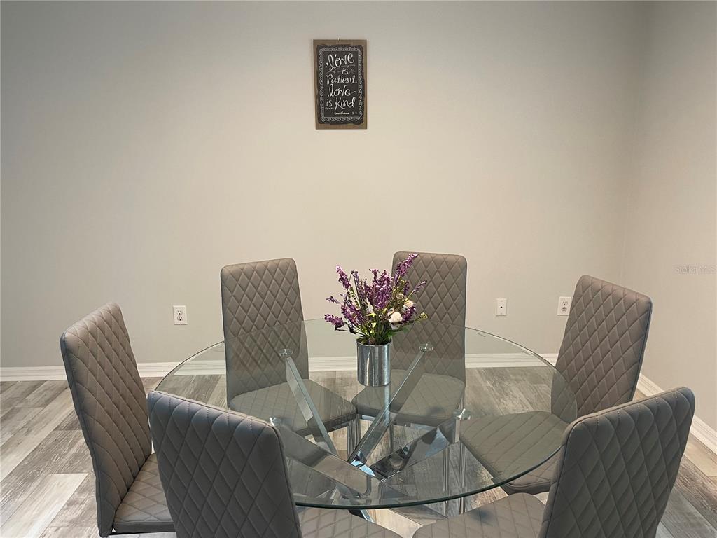 21 Post View Drive Palm Coast, FL 32164 - Photo 3 of 28 a dining room with furniture and a potted plant