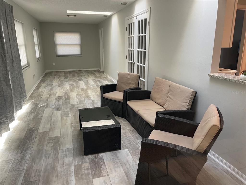 21 Post View Drive Palm Coast, FL 32164 - Photo 4 of 28 a living room with furniture and a flat screen tv
