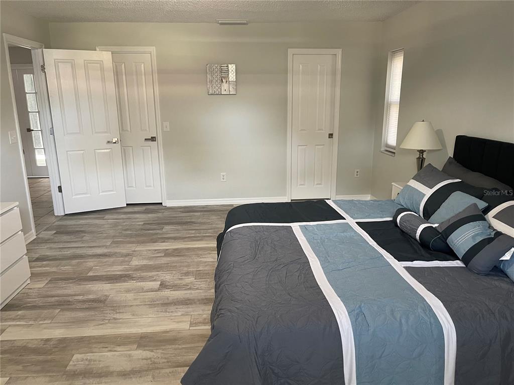 21 Post View Drive Palm Coast, FL 32164 - Photo 6 of 28 a bedroom with a bed and a lamp