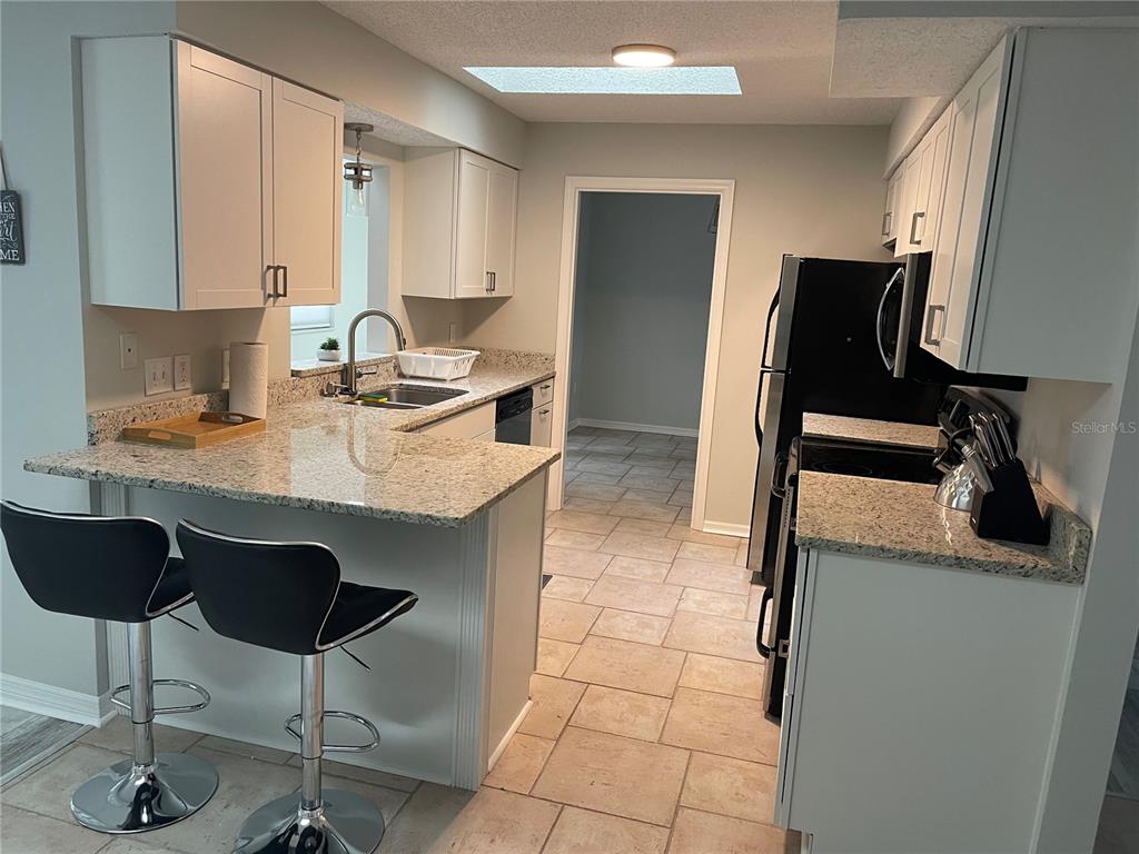 21 Post View Drive Palm Coast, FL 32164 - Photo 8 of 28 a kitchen with a sink cabinets and stove top oven