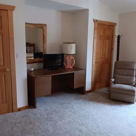 a view of living room and bedroom with furniture