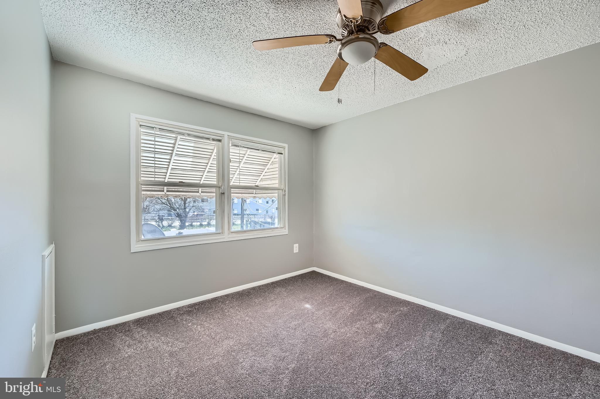 2023 Larkhall Road Dundalk, MD 21222 - Photo 7 of 11 an empty room with windows and fan