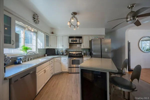 a kitchen with a sink appliances and cabinets