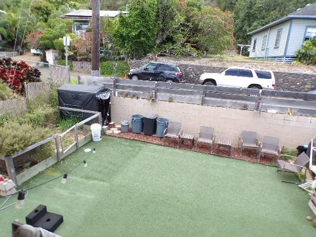 a view of backyard with outdoor seating and barbeque oven