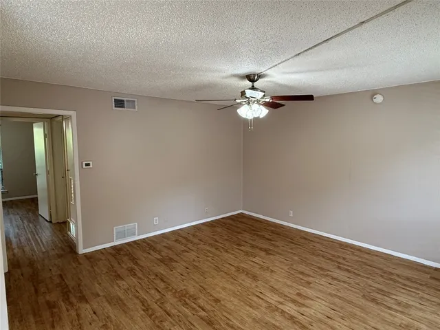 a view of a room with wooden floor