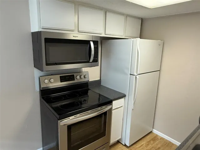 a kitchen with a stove and a microwave