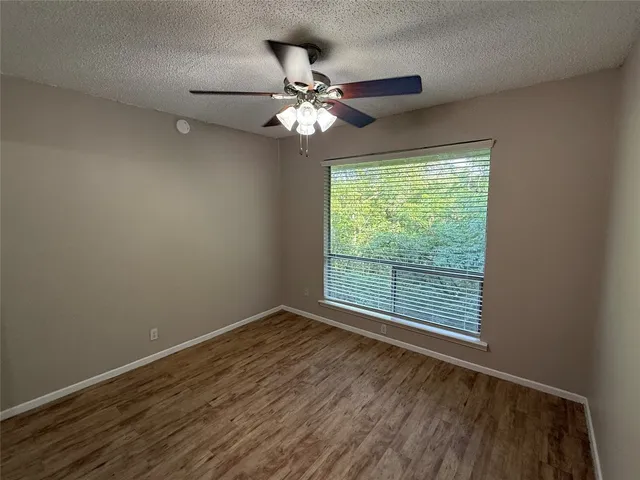 a view of room with window and ceiling fan