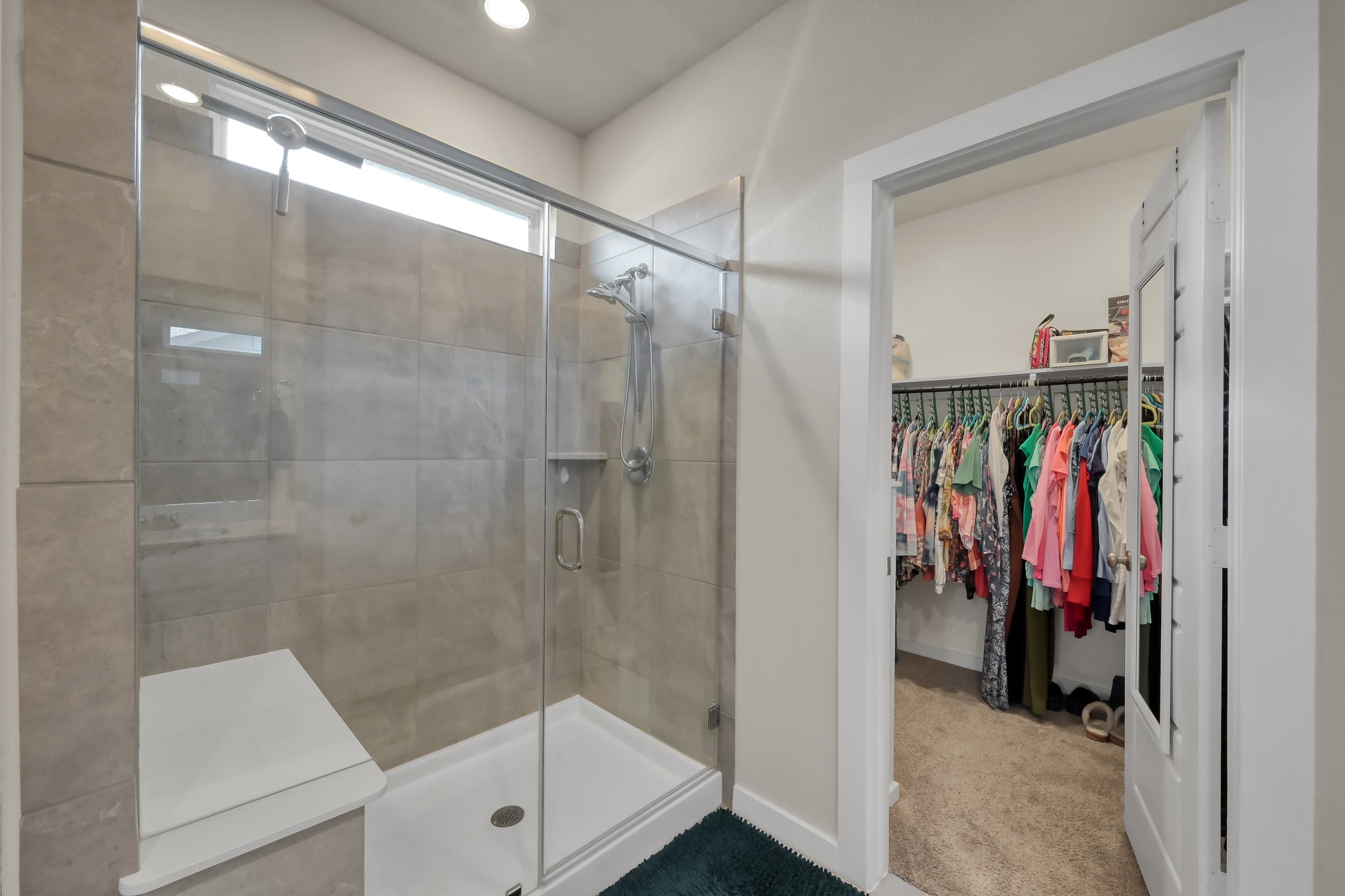 372 Sunrise Rnch Drive Montgomery, TX 77316 - Photo 14 of 32 The spacious glass-enclosed shower includes a bench seat & close by is the enormous walk-in primary closet